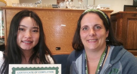 Youth volunteer Patty pictured with Assistant Store Manager Tara with her completion certificate.